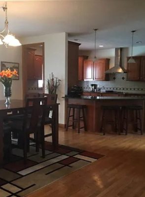 before photo of kitchen with dark cabinets and furniture.