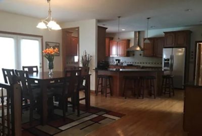 before photo of kitchen with dark cabinets and furniture.