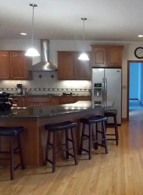 before photo of kitchen with dark cabinets and furniture.
