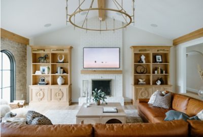 living room with neutral walls, floor, and brown couch.