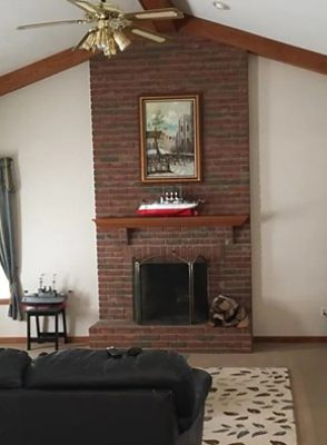 before photo of living room with dark features.