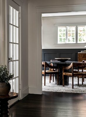 peek into a dining room surrounded by some windows.
