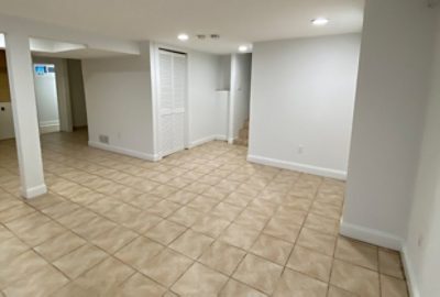 before photo of an empty room with white walls and tile flooring.