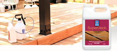 A stained wood deck with a sprayer to apply Sherwin-Williams SuperDeck deck wash.