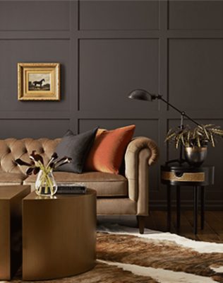 Dark gray walls with bronze couch, table and side table.