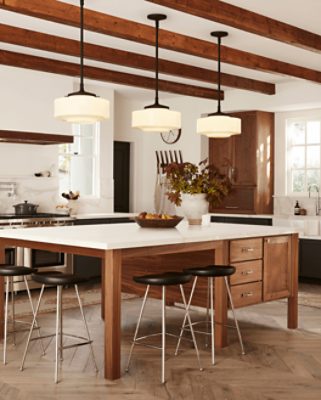 A kitchen with stained wood ceiling beams along with stained wood cabinets.