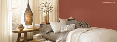 A boho-inspired bedroom painted Sierra Redwood SW 7598.