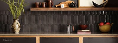 A countertop with dark brown tiles under one shelf with walls painted Clove SW 9605.