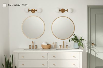 A bathroom with a double vanity and gold accents painted in Pure White SW 7005.