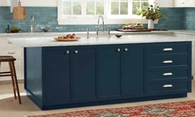 A kitchen island painted a dark gray blue.