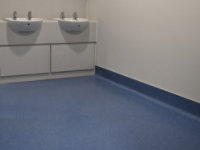 durable blue flooring in commercial restroom
