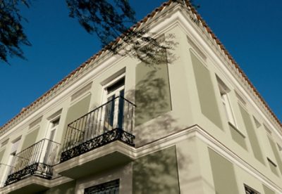 A neutral color exterior building with white trim.