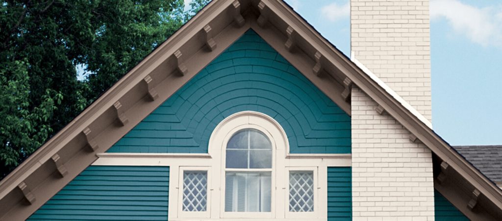 Front exterior view of a blue bungalow with white trim - Stock Photo -  Dissolve
