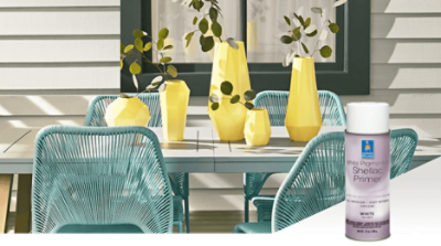 A patio table with four blue chairs and yellow vases. White pigmented Shellac Primer.
