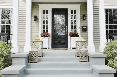 Brick steps painted gray leading to a black front door.