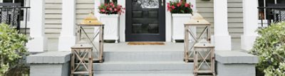 Brick steps painted gray leading to a black front door.