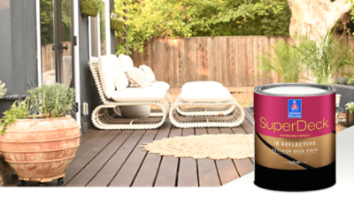 A backyard deck with white patio furniture and a potted plant. Sherwin-Williams SuperDeck.