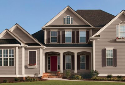 A house with browns, a red door, and windows.