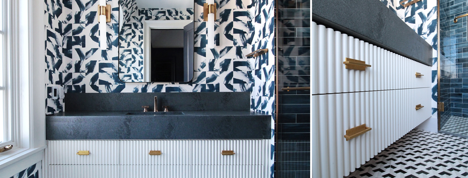 Full view and angled closeup of fluted white vanity with dark countertop and bold patterned wallpaper, dark blue tiled walk-in shower at right.