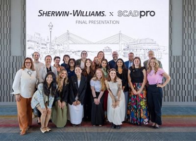 Group of people standing and smiling in front of a backdrop with "SHERWIN-WILLIAMS x SCADpro FINAL PRESENTATION" text.
