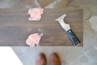 A laminated dresser drawer with a scraper and paint stripper.