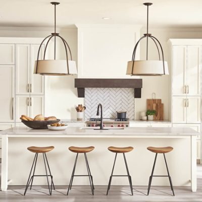 A neutral white kitchen space with brown chairs.