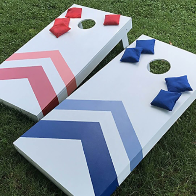 Two cornhole boards painted red and blue