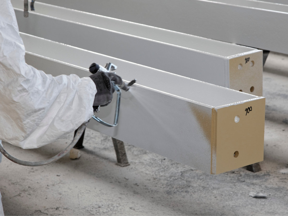 Coating is applied to a steel beam in an application shop