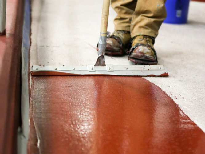 resinous floor application with squeegee