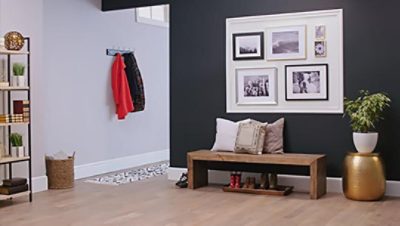 An entryway with a gallery wall, bench, flowerpot and bookshelf