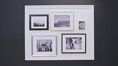A home gallery wall with portraits and pictures shown