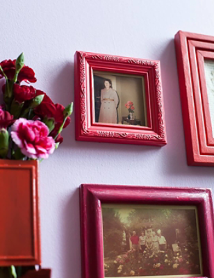 Large pink and red picture frames hanging on the wall with flowers