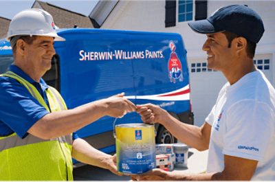 A Sherwin-Williams employee delivering paint to a contractor.