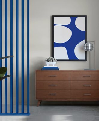 Wooden furniture with drawers, minimal decor, vertical slats painted in SW 6967 Frank Blue to the left.