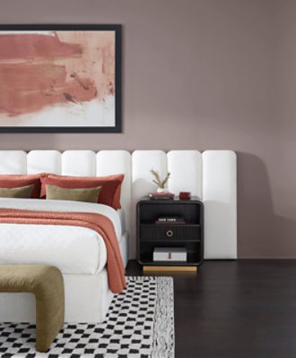 Bedroom painted in Chinchilla SW 6011 with white headboard and white bedspread with dark nightstand.