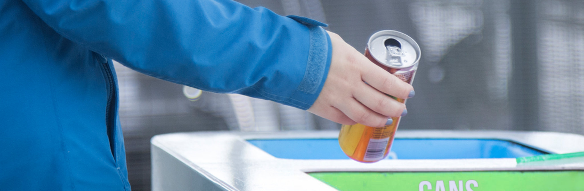 tossing beverage can in recycling container