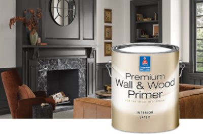 A formal living room with a black fireplace. A can of Sherwin-Williams Premium Wall & Wood primer in the foreground.