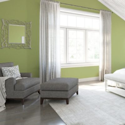A bedroom with green walls.