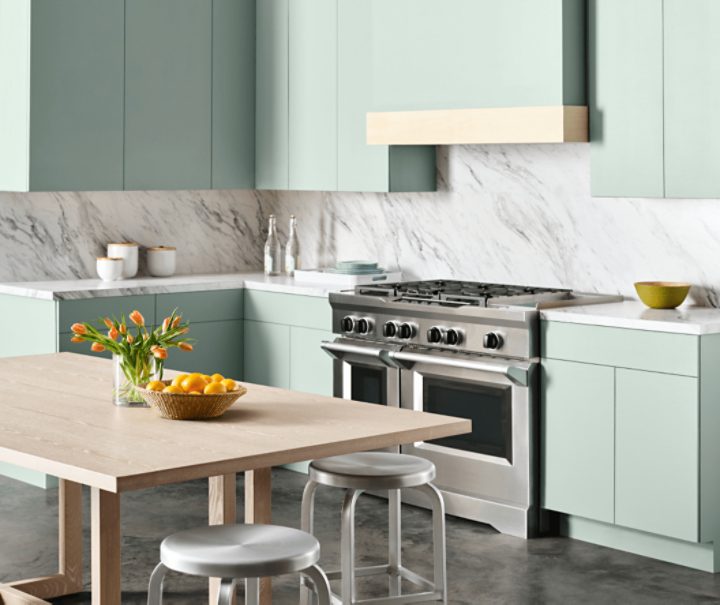A modern kitchen with cabinets painted in Halcyon Green SW 6213.