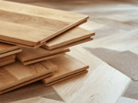 Stack of engineered wood flooring planks, highlighting material structure, surface finish, and installation readiness.