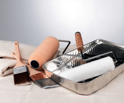 Painting supplies on a drop cloth.