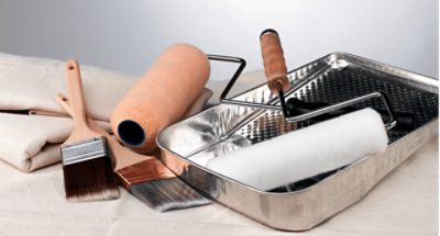 Painting supplies on a drop cloth.