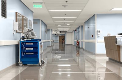 A hospital hallway painted light blue.