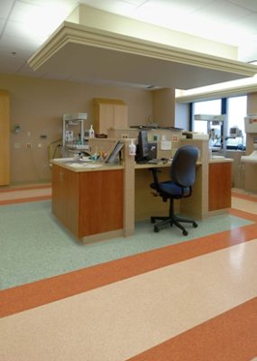 A work station in a healthcare facility with colored tile flooring.