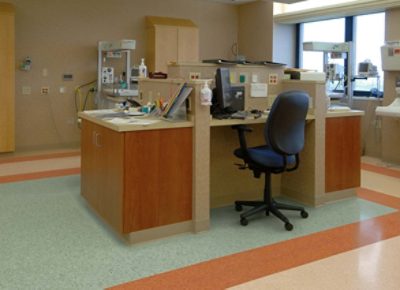 A work station in a healthcare facility with colored tile flooring.