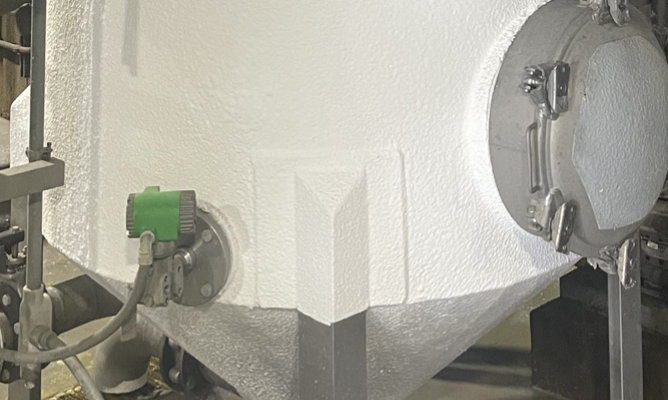 Stainless steel industrial tank covered in insulation