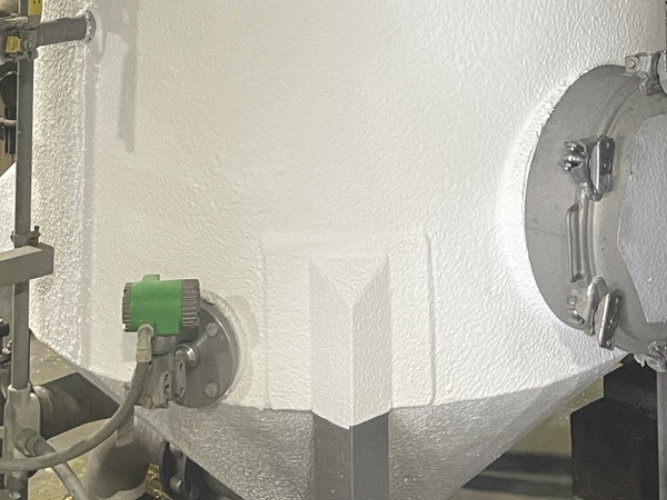 Stainless steel industrial tank covered in insulation
