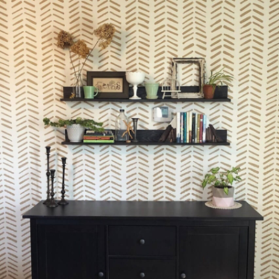 A herringbone patterned wallpaper with shelves.
