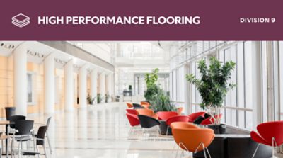 High performance flooring. Division 9. An atrium with bright colored chairs and potted trees.