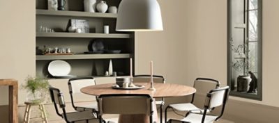 A beige and neutral dining room space with dark decor.